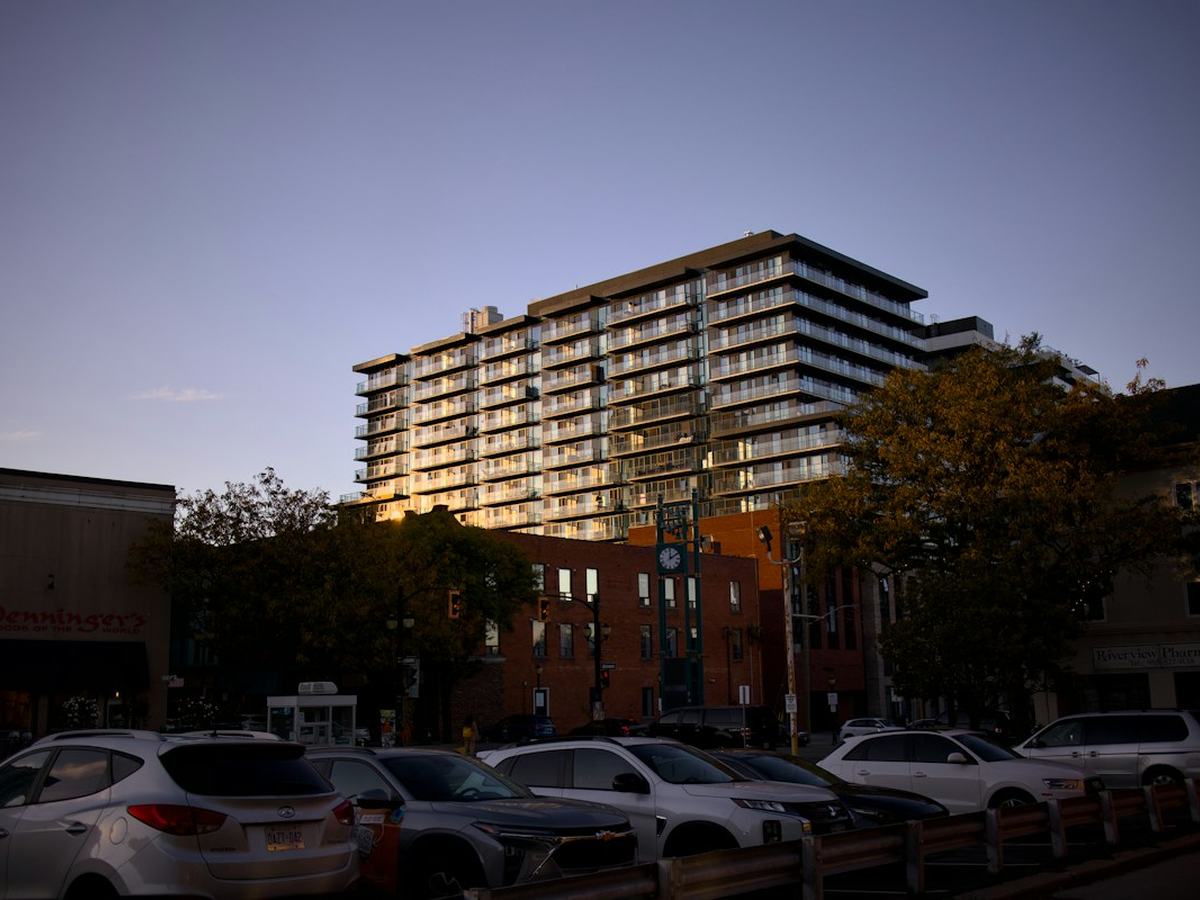 Apartment building with balconies at sunset