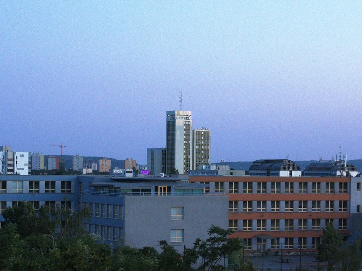 Cityscape with a tall central tower at dusk